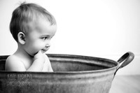 thoughtful toddler in a bathtub