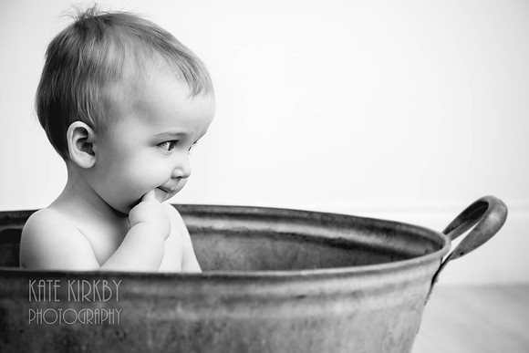 thoughtful toddler in a bathtub