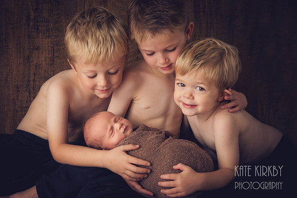 four brothers with newborn