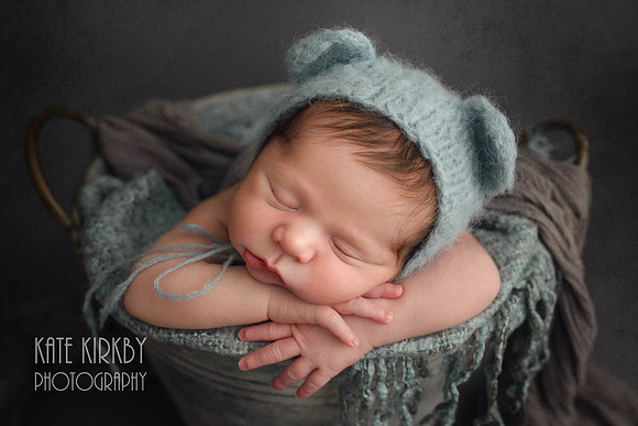 sleeping newborn in teddy ear hat
